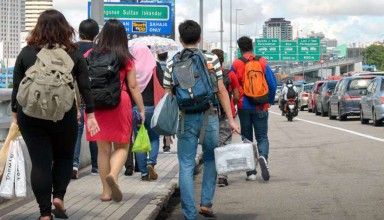 Malaysians walking across the Causeway to Johor Baru