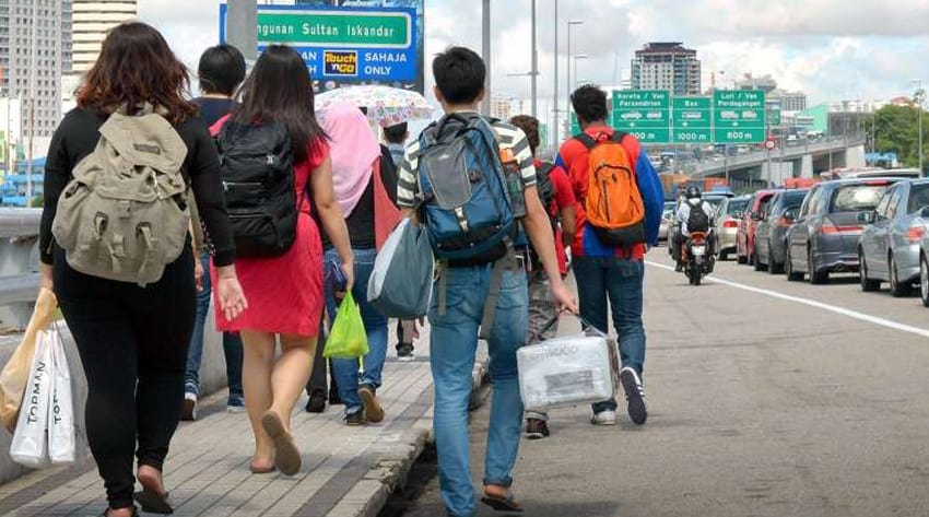 Malaysians walking across the Causeway to Johor Baru