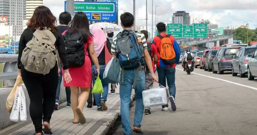 Malaysians walking across the Causeway to Johor Baru
