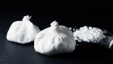 cocaine poured bag on black background