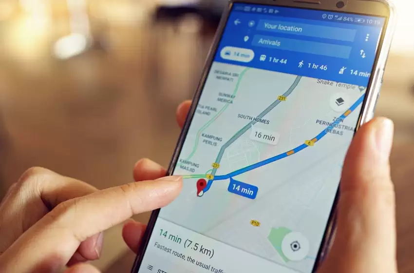 A girl is using Google Maps service on smartphone at cafe