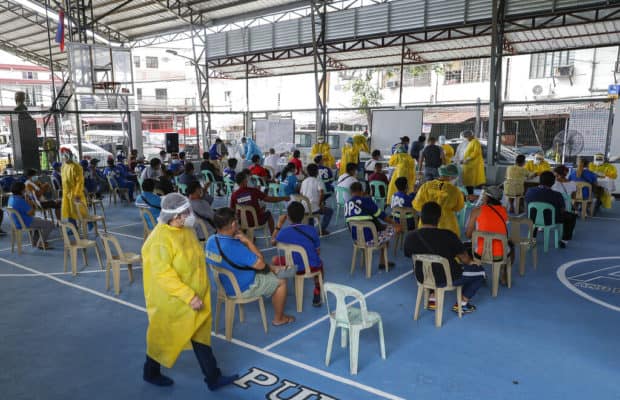 Resident wait Residents wait for their turn during a mass testing for COVID-19 in Manila