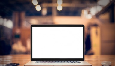 Laptop with blank screen on table