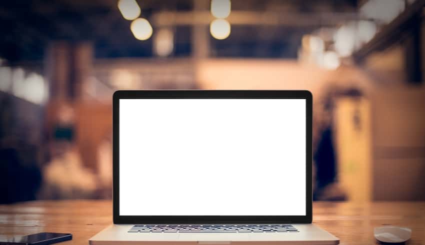 Laptop with blank screen on table