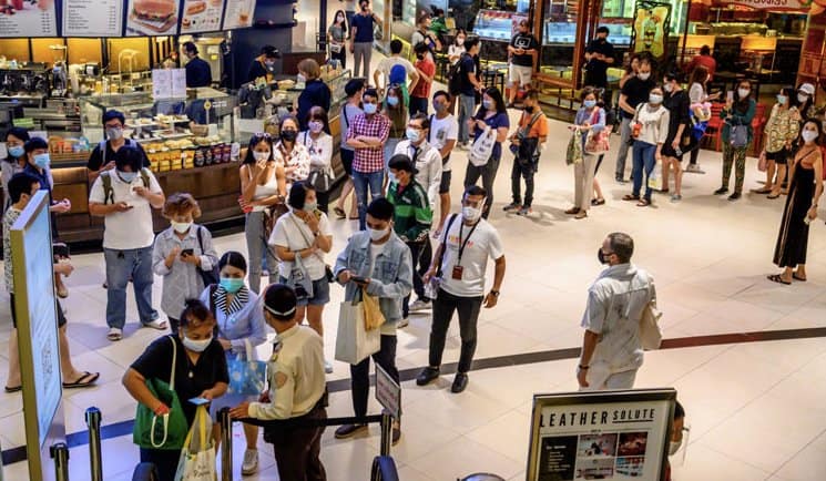 Shoppers lined up to enter Thailand’s shopping malls