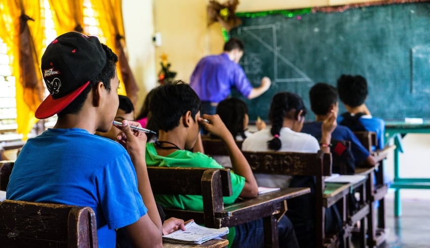 A student follows along as his teacher teaches in Philippines