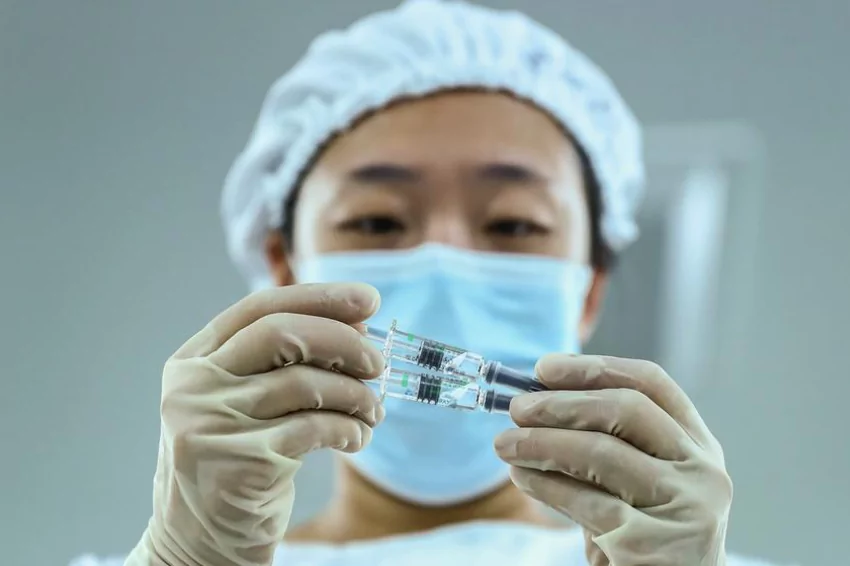 China insists COVID-19 vaccines are safe and shows leaders got injections
