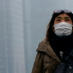 people wearing face masks walk on a street following the coronavirus disease (covid 19) outbreak, in shanghai