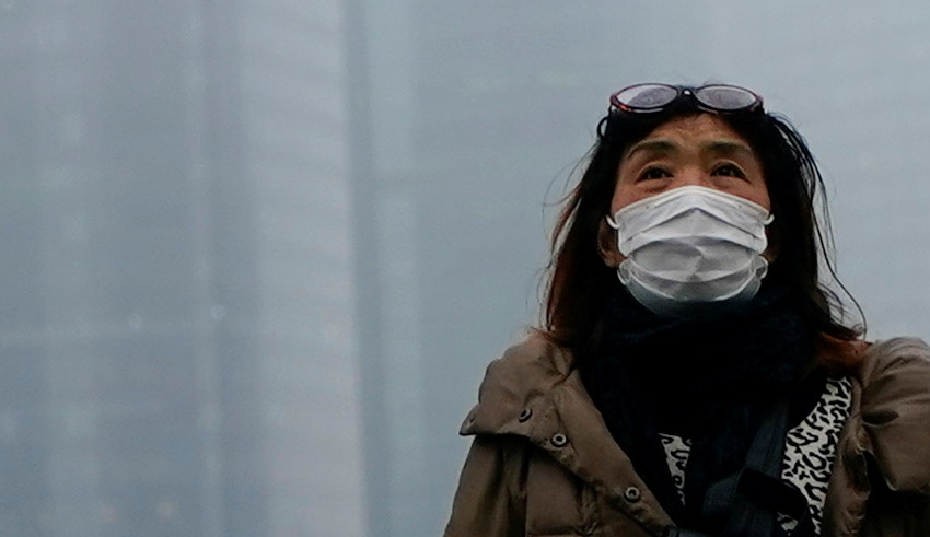 people wearing face masks walk on a street following the coronavirus disease (covid 19) outbreak, in shanghai