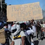 to protest officer deaths, haiti police block roadways and breach into airports