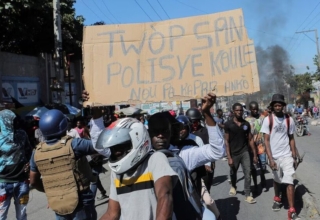 to protest officer deaths, haiti police block roadways and breach into airports
