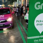 a grab pick up and drop off station is seen at the entrance of kuala lumpur city centre in kuala lumpur