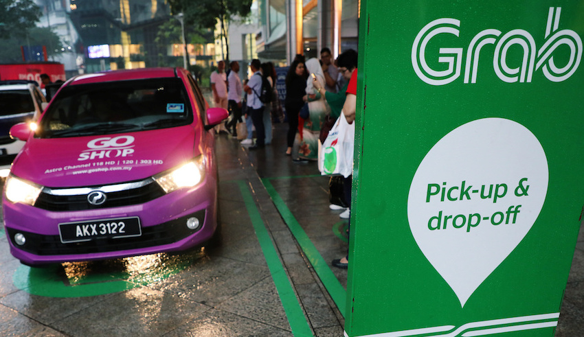 a grab pick up and drop off station is seen at the entrance of kuala lumpur city centre in kuala lumpur