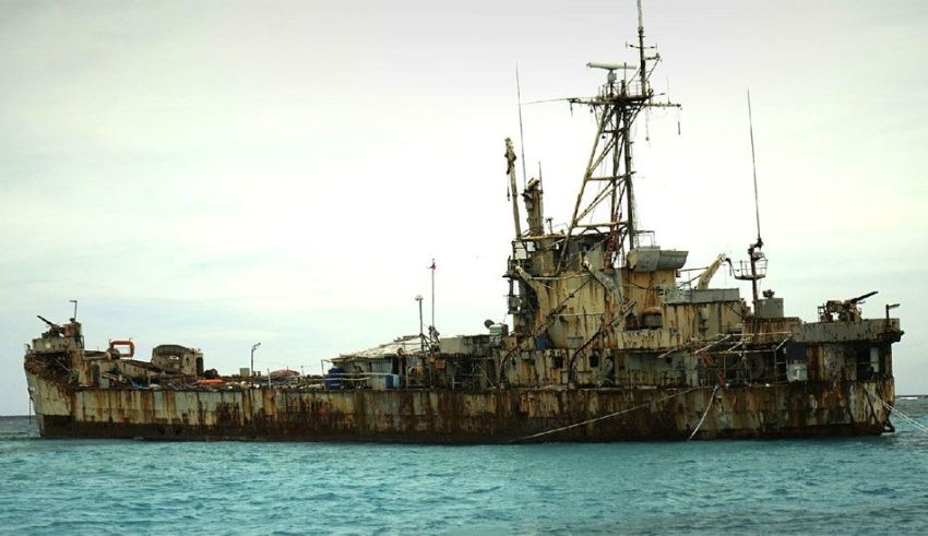 china on tuesday repeated its call for the philippines to remove a warship from a disputed shoal, after manila strongly stressed it would not abandon the area.