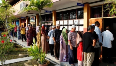 malaysians working in singapore cast ballots despite downpour